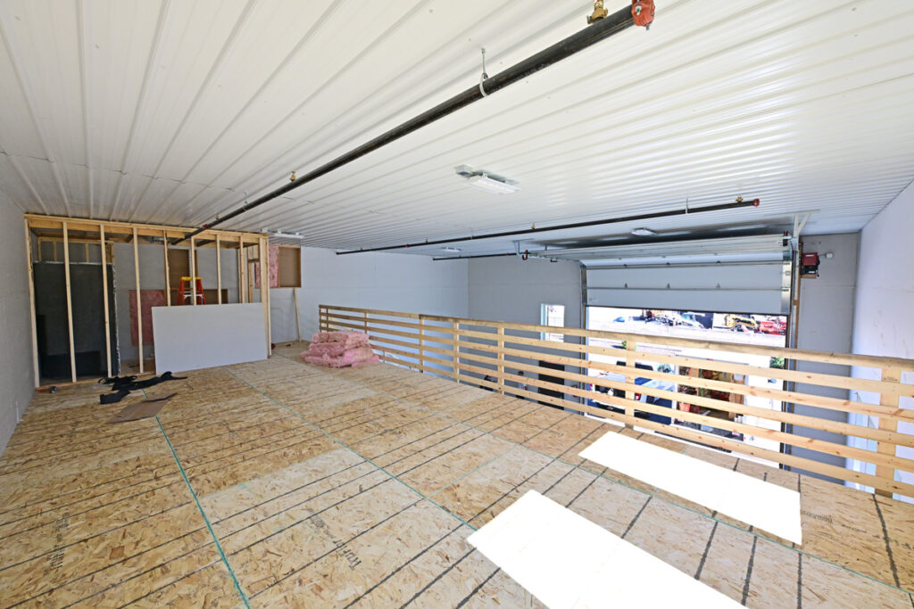 A mezzanine under construction in a car condo unit.