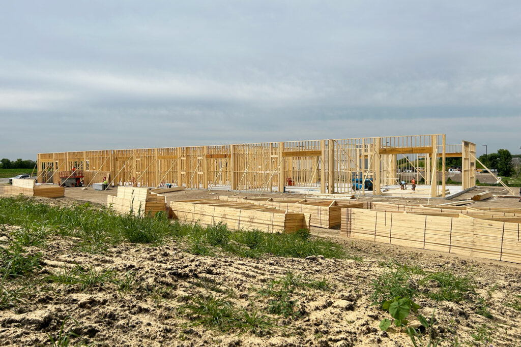 A large building being framed out of wood.