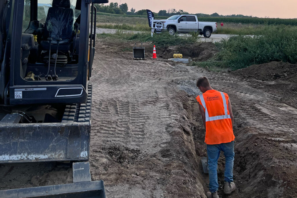 A construction worker works in a trench.