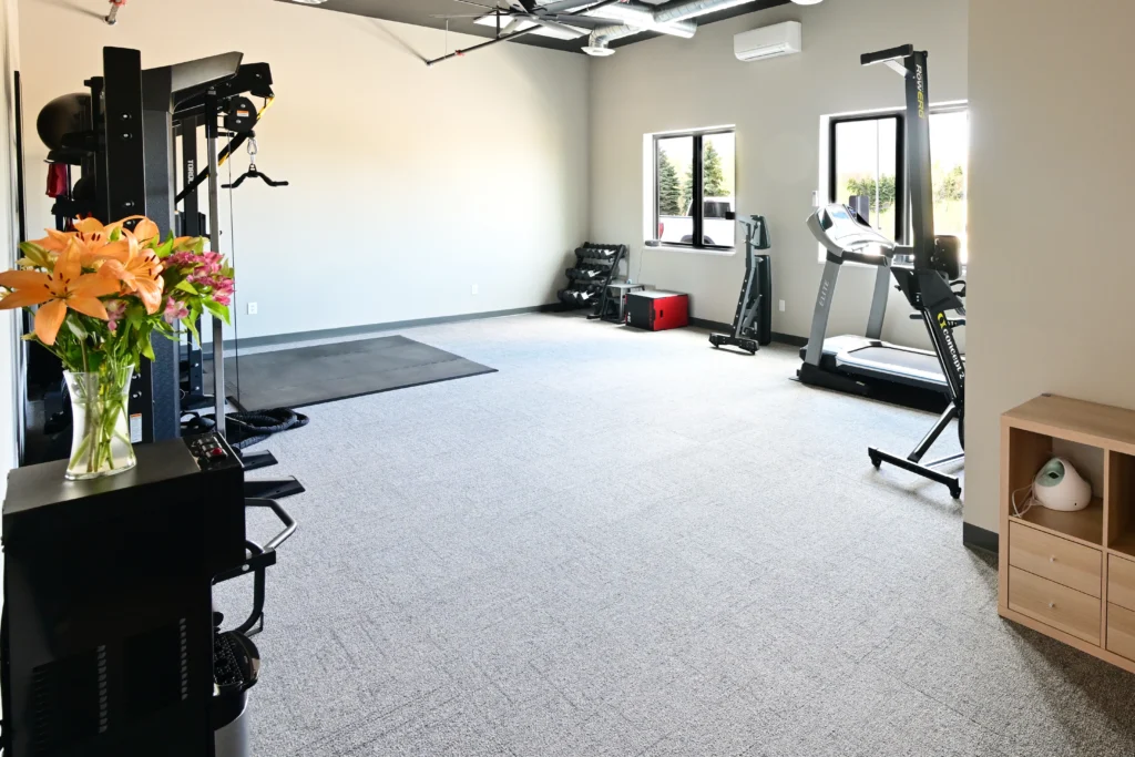 A room with workout equipment inside.