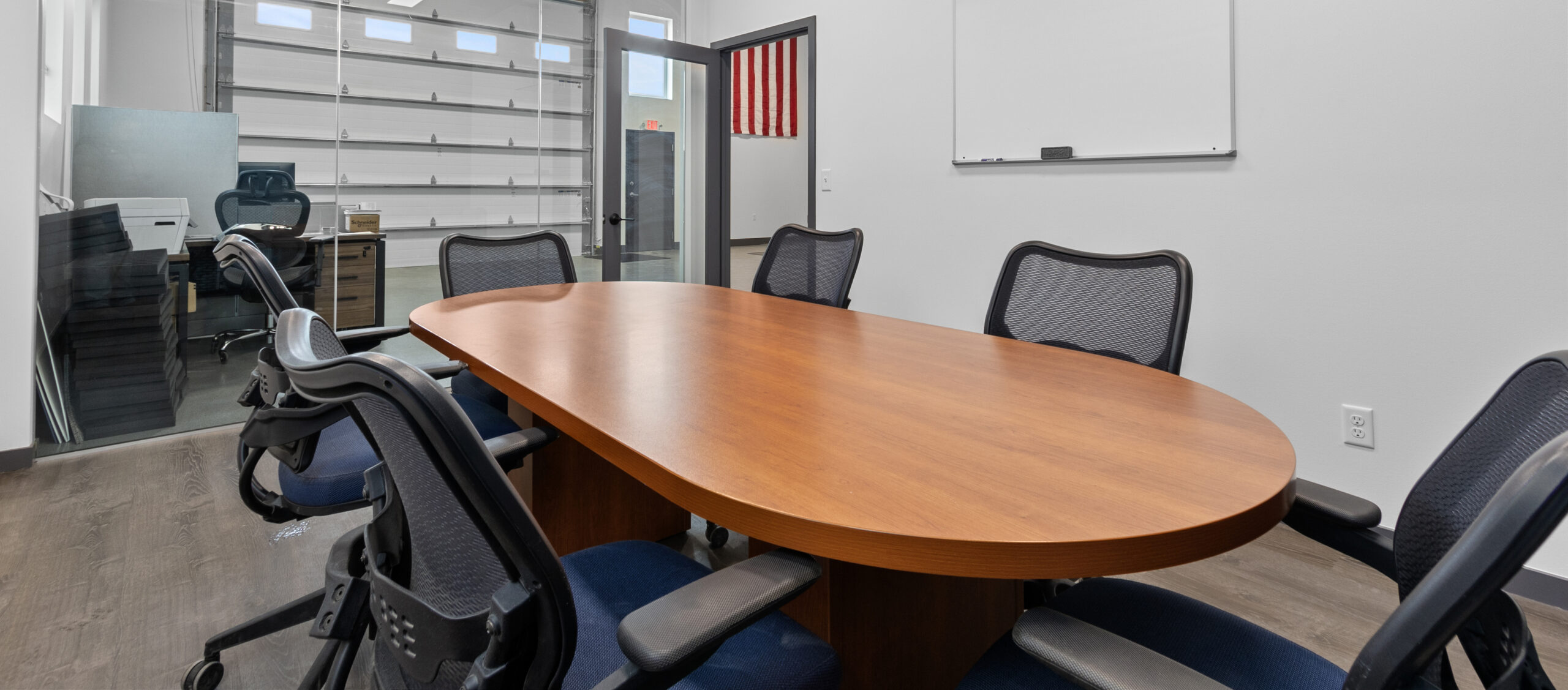 A conference room with a table and several chairs.