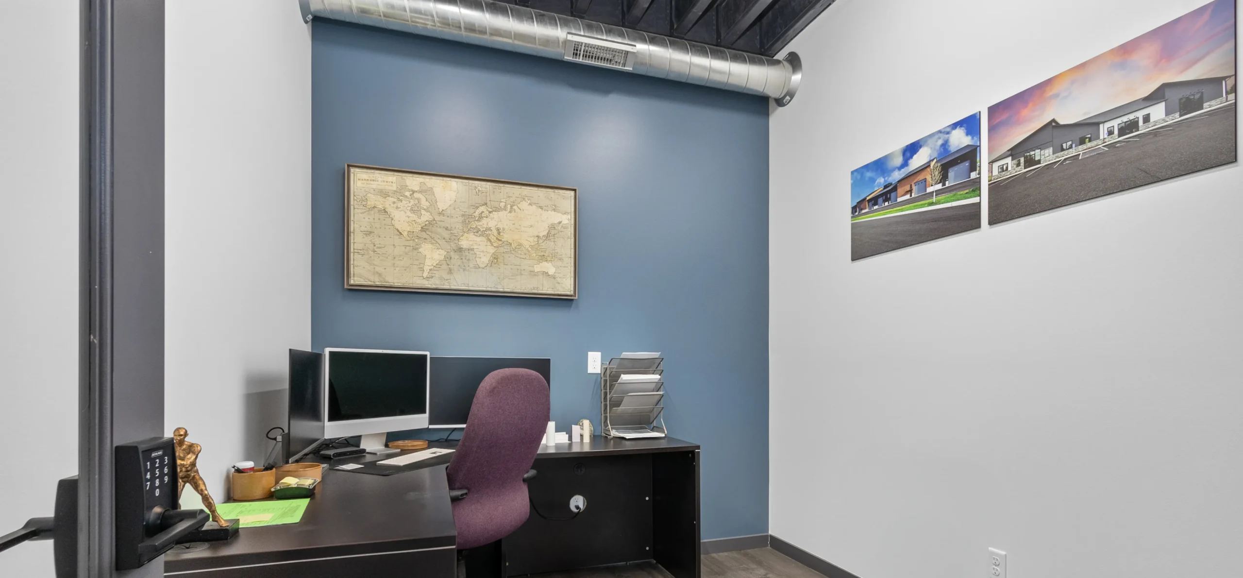 An office with photographic prints on the wall.
