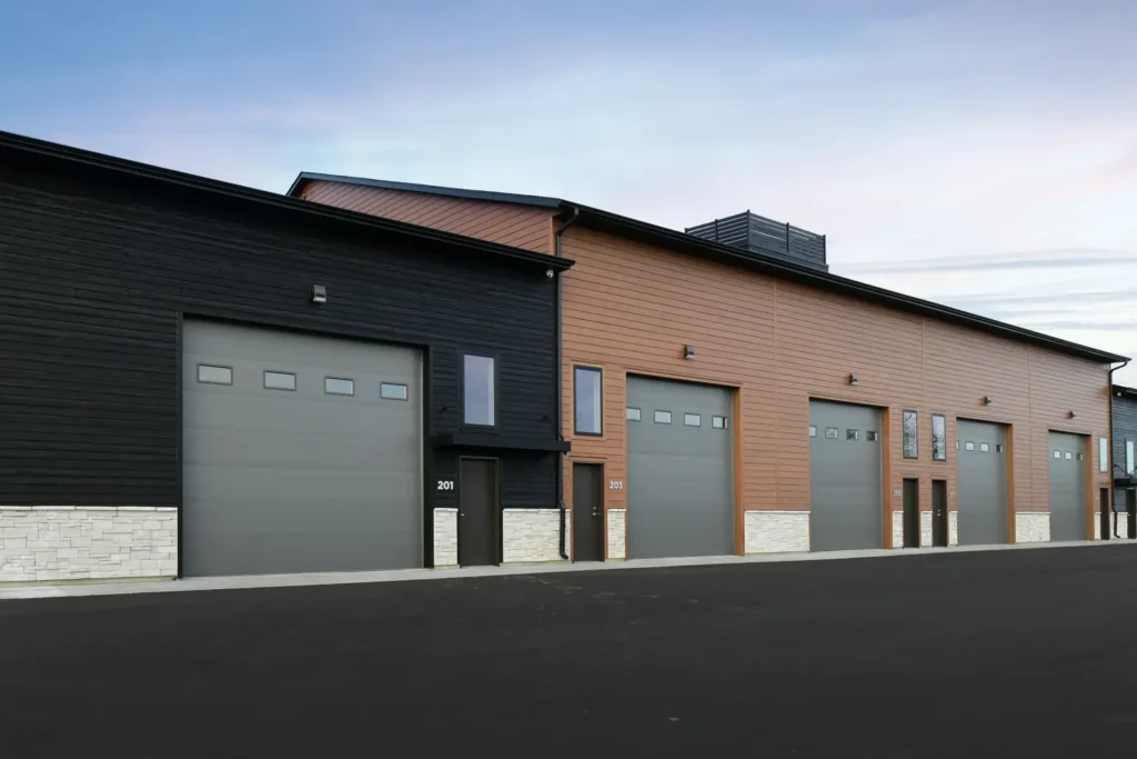 A large building with multiple commercial garage doors.
